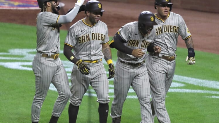 Jun 30, 2021; Cincinnati, Ohio, USA; San Diego Padres center fielder Trent Grisham (second from right) celebrates with shortstop Fernando Tatis Jr. (left) left fielder Tommy Pham (28) and third baseman Manny Machado (right) after hitting a grand slam against the Cincinnati Reds during the fifth inning at Great American Ball Park. Mandatory Credit: David Kohl-USA TODAY Sports