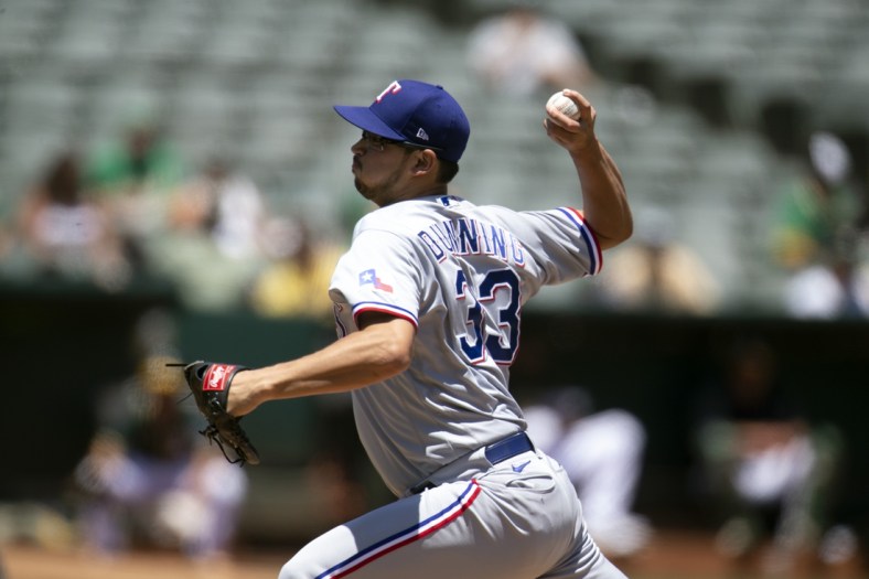 Jul 1, 2021; Oakland, California, USA; Texas Rangers starting pitcher Dane Dunning (33) delivers a pitch against the Oakland Athletics in the second inning at RingCentral Coliseum. Mandatory Credit: D. Ross Cameron-USA TODAY Sports
