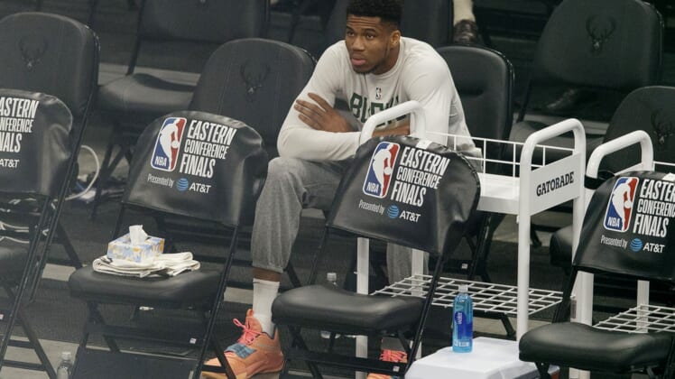 Jul 1, 2021; Milwaukee, Wisconsin, USA;  Milwaukee Bucks forward Giannis Antetokounmpo sits on the sidelines during warmups before game five of the Eastern Conference Finals against the Atlanta Hawks during the 2021 NBA Playoffs at Fiserv Forum. Mandatory Credit: Jeff Hanisch-USA TODAY Sports