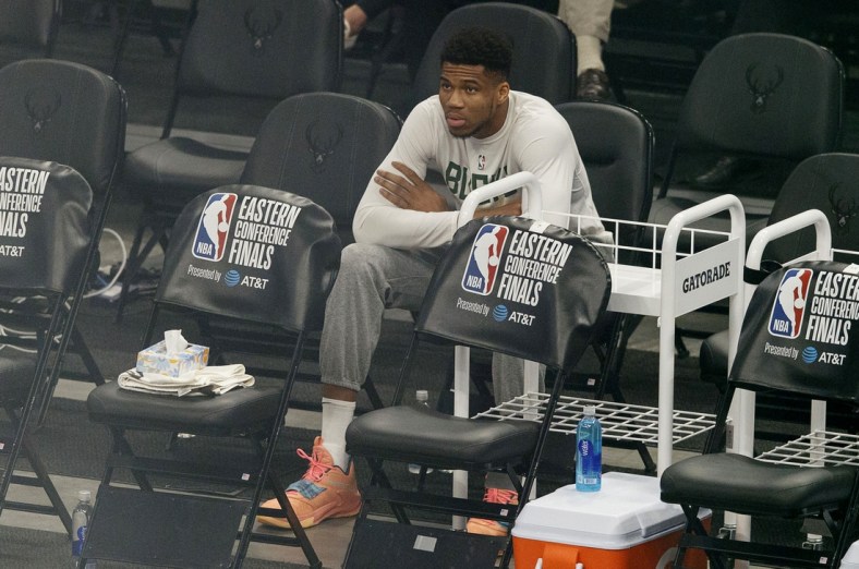 Jul 1, 2021; Milwaukee, Wisconsin, USA;  Milwaukee Bucks forward Giannis Antetokounmpo sits on the sidelines during warmups before game five of the Eastern Conference Finals against the Atlanta Hawks during the 2021 NBA Playoffs at Fiserv Forum. Mandatory Credit: Jeff Hanisch-USA TODAY Sports