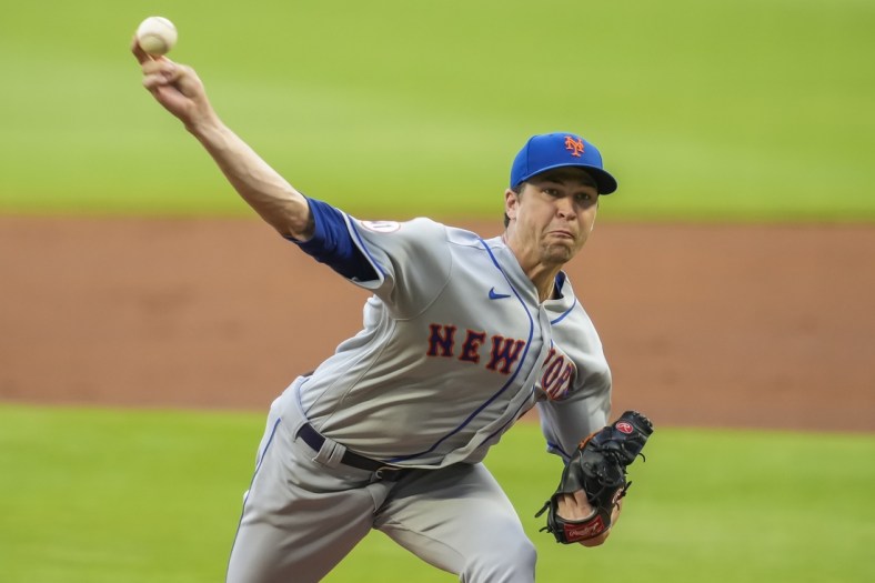 Jul 1, 2021; Cumberland, Georgia, USA; New York Mets starting pitcher Jacob deGrom (48) pitches against the Atlanta Braves during the first inning at Truist Park. Mandatory Credit: Dale Zanine-USA TODAY Sports