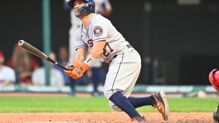 Jul 1, 2021; Cleveland, Ohio, USA; Houston Astros second baseman Jose Altuve (27) hits a grand slam during the fifth inning against the Cleveland Indians at Progressive Field. Mandatory Credit: Ken Blaze-USA TODAY Sports