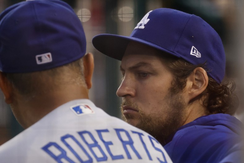 Jul 1, 2021; Washington, District of Columbia, USA; Los Angeles Dodgers starting pitcher Trevor Bauer (R) talks with Dodgers manager Dave Roberts (L) in the dugout against the Washington Nationals in the third inning at Nationals Park. Mandatory Credit: Geoff Burke-USA TODAY Sports
