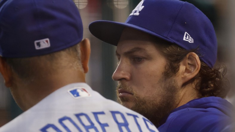 Jul 1, 2021; Washington, District of Columbia, USA; Los Angeles Dodgers starting pitcher Trevor Bauer (R) talks with Dodgers manager Dave Roberts (L) in the dugout against the Washington Nationals in the third inning at Nationals Park. Mandatory Credit: Geoff Burke-USA TODAY Sports