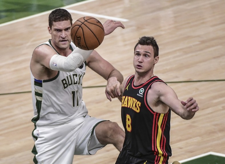Jul 1, 2021; Milwaukee, Wisconsin, USA; Milwaukee Bucks center Brook Lopez (11) and Atlanta Hawks forward Danilo Gallinari (8) battle for a rebound in the second quarter during game five of the Eastern Conference Finals for the 2021 NBA Playoffs at Fiserv Forum. Mandatory Credit: Benny Sieu-USA TODAY Sports