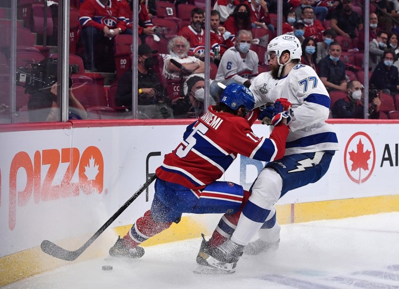 Jul 2, 2021; Montreal, Quebec, CAN; Montreal Canadiens center Jesperi Kotkaniemi (15) and Tampa Bay Lightning defenseman Victor Hedman (77) battle for the puck during the first period in game three of the 2021 Stanley Cup Final at the Bell Centre. Mandatory Credit: Eric Bolte-USA TODAY Sports