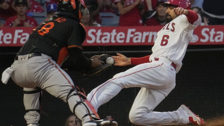 Jul 2, 2021; Anaheim, California, USA; Los Angeles Angels third baseman Anthony Rendon (6) slides into home as Baltimore Orioles catcher Pedro Severino waits with the ball during the third inning at Angel Stadium.Rendon was safe on the play.  Mandatory Credit: Robert Hanashiro-USA TODAY Sports