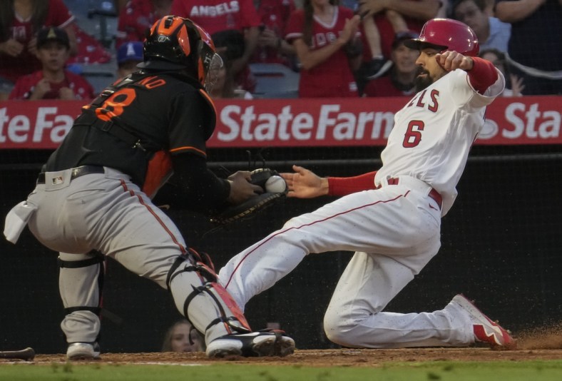 Jul 2, 2021; Anaheim, California, USA; Los Angeles Angels third baseman Anthony Rendon (6) slides into home as Baltimore Orioles catcher Pedro Severino waits with the ball during the third inning at Angel Stadium.Rendon was safe on the play.  Mandatory Credit: Robert Hanashiro-USA TODAY Sports