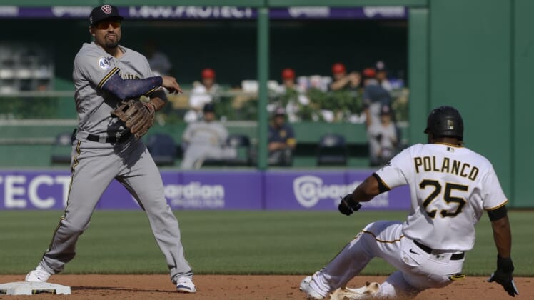 Jul 3, 2021; Pittsburgh, Pennsylvania, USA;  Milwaukee Brewers second baseman Jace Peterson (14) throws to first base to completes a double play over the Pittsburgh Pirates  pinch hitter right fielder Gregory Polanco (25) during the fifth inning at PNC Park. Mandatory Credit: Charles LeClaire-USA TODAY Sports