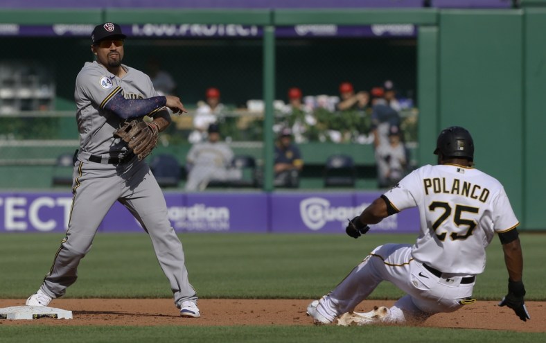 Jul 3, 2021; Pittsburgh, Pennsylvania, USA;  Milwaukee Brewers second baseman Jace Peterson (14) throws to first base to completes a double play over the Pittsburgh Pirates  pinch hitter right fielder Gregory Polanco (25) during the fifth inning at PNC Park. Mandatory Credit: Charles LeClaire-USA TODAY Sports