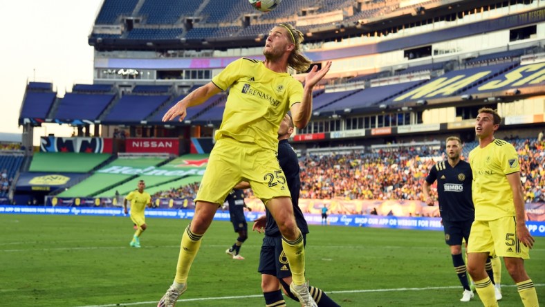 Jul 3, 2021; Nashville, TN, Nashville, TN, USA; Nashville SC defender Walker Zimmerman (25) heads the ball out of the box against the Philadelphia Union during the first half at Nissan Stadium. Mandatory Credit: Christopher Hanewinckel-USA TODAY Sports