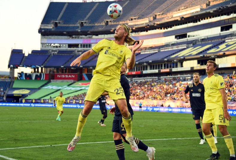 Jul 3, 2021; Nashville, TN, Nashville, TN, USA; Nashville SC defender Walker Zimmerman (25) heads the ball out of the box against the Philadelphia Union during the first half at Nissan Stadium. Mandatory Credit: Christopher Hanewinckel-USA TODAY Sports