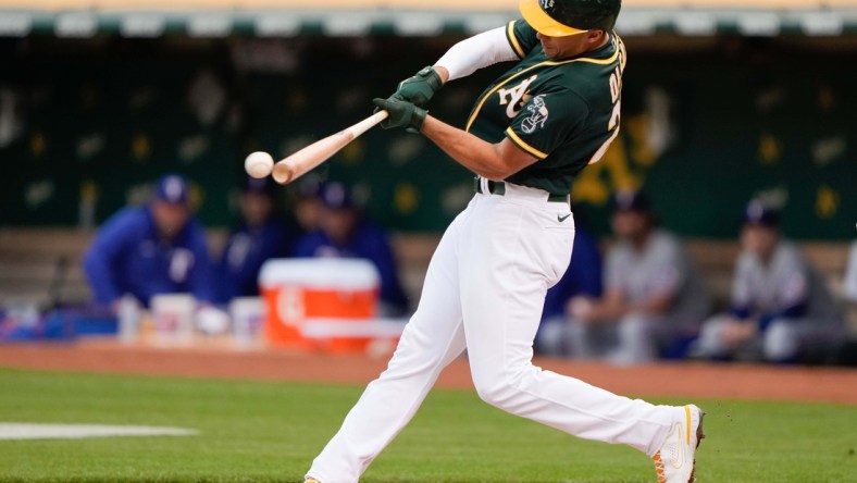 Jun 30, 2021; Oakland, California, USA;  Oakland Athletics first baseman Matt Olson (28) hits the ball during the first inning against the Texas Rangers at RingCentral Coliseum. Mandatory Credit: Stan Szeto-USA TODAY Sports