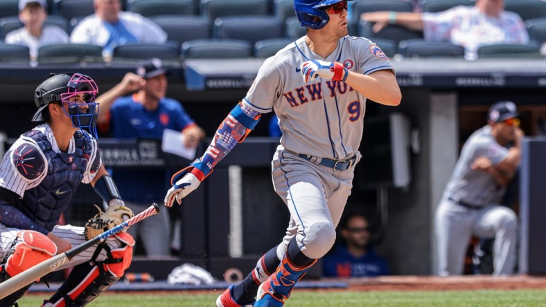 Jul 4, 2021; Bronx, New York, USA; New York Mets center fielder Brandon Nimmo (9) hits an RBI single during the fourth inning against the New York Yankees at Yankee Stadium. Mandatory Credit: Vincent Carchietta-USA TODAY Sports