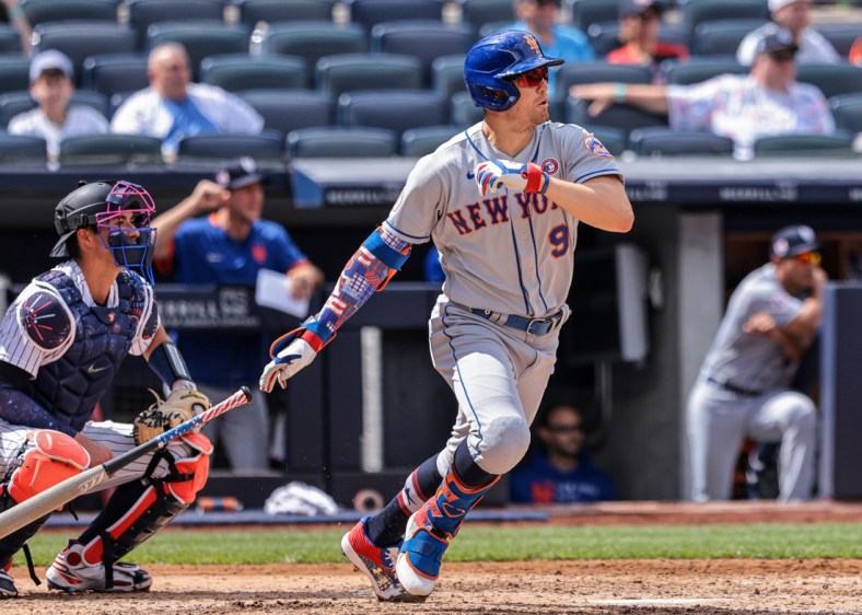 Jul 4, 2021; Bronx, New York, USA; New York Mets center fielder Brandon Nimmo (9) hits an RBI single during the fourth inning against the New York Yankees at Yankee Stadium. Mandatory Credit: Vincent Carchietta-USA TODAY Sports