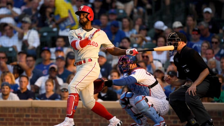 Jul 5, 2021; Chicago, Illinois, USA; Philadelphia Phillies center fielder Andrew McCutchen (22) hits a double in the second inning against the Chicago Cubs at Wrigley Field. Mandatory Credit: Quinn Harris-USA TODAY Sports