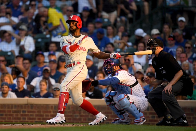 Jul 5, 2021; Chicago, Illinois, USA; Philadelphia Phillies center fielder Andrew McCutchen (22) hits a double in the second inning against the Chicago Cubs at Wrigley Field. Mandatory Credit: Quinn Harris-USA TODAY Sports