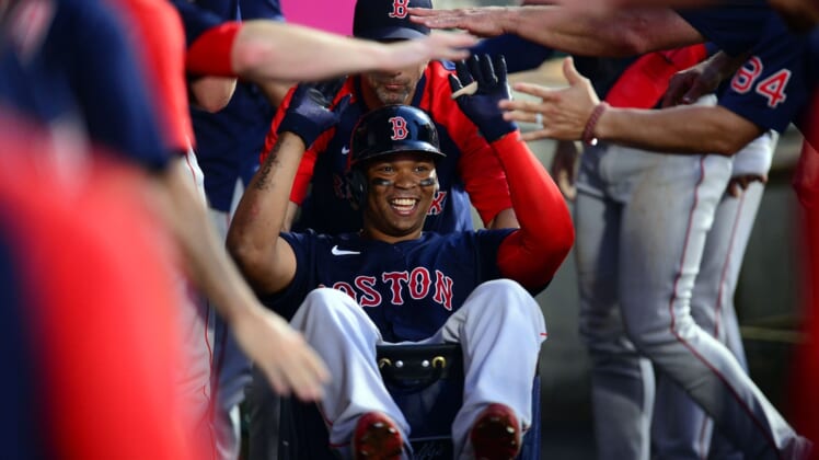Jul 5, 2021; Anaheim, California, USA; Boston Red Sox third baseman Rafael Devers (11) celebrates his two run home run hit against the Los Angeles Angels during the fourth inning at Angel Stadium. Mandatory Credit: Gary A. Vasquez-USA TODAY Sports