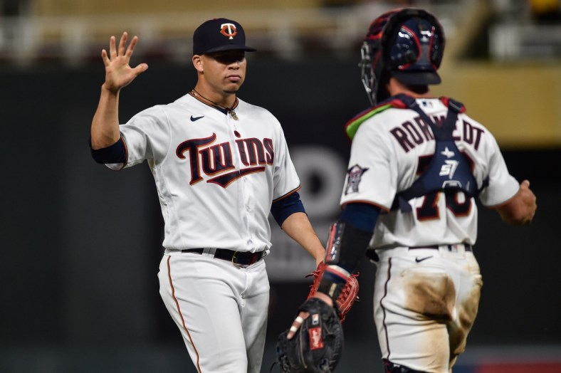 Jul 5, 2021; Minneapolis, Minnesota, USA; Minnesota Twins relief pitcher Hansel Robles (57) and catcher Ben Rortvedt (70) react after the game against the Chicago White Sox at Target Field. Robles earned a save for his efforts.  Mandatory Credit: Jeffrey Becker-USA TODAY Sports