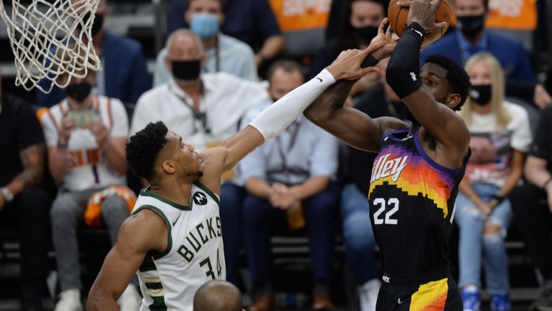 Jul 6, 2021; Phoenix, Arizona, USA; Phoenix Suns center Deandre Ayton (22) shoots against Milwaukee Bucks forward Giannis Antetokounmpo (34) during the first half in game one of the 2021 NBA Finals at Phoenix Suns Arena. Mandatory Credit: Joe Camporeale-USA TODAY Sports