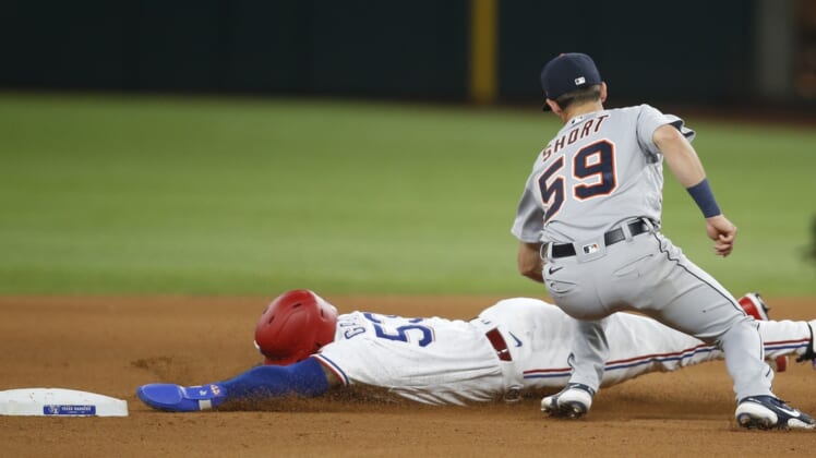 Jul 6, 2021; Arlington, Texas, USA; Detroit Tigers shortstop Zack Short (59) tags out Texas Rangers center fielder Adolis Garcia (53) as he attempts to steal second base in the fourth inning at Globe Life Field. Mandatory Credit: Tim Heitman-USA TODAY Sports