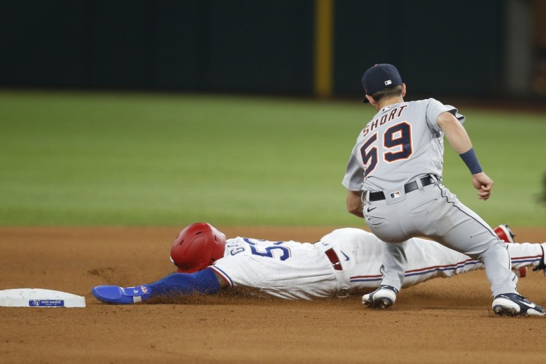 Jul 6, 2021; Arlington, Texas, USA; Detroit Tigers shortstop Zack Short (59) tags out Texas Rangers center fielder Adolis Garcia (53) as he attempts to steal second base in the fourth inning at Globe Life Field. Mandatory Credit: Tim Heitman-USA TODAY Sports