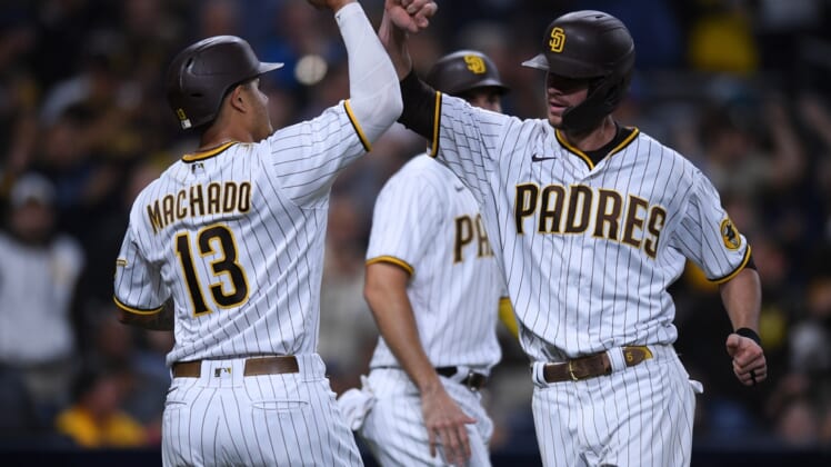 Jul 6, 2021; San Diego, California, USA; San Diego Padres right fielder Wil Myers (right) is congratulated by third baseman Manny Machado (13) after hitting a three-run home run against the Washington Nationals during the fourth inning at Petco Park. Mandatory Credit: Orlando Ramirez-USA TODAY Sports