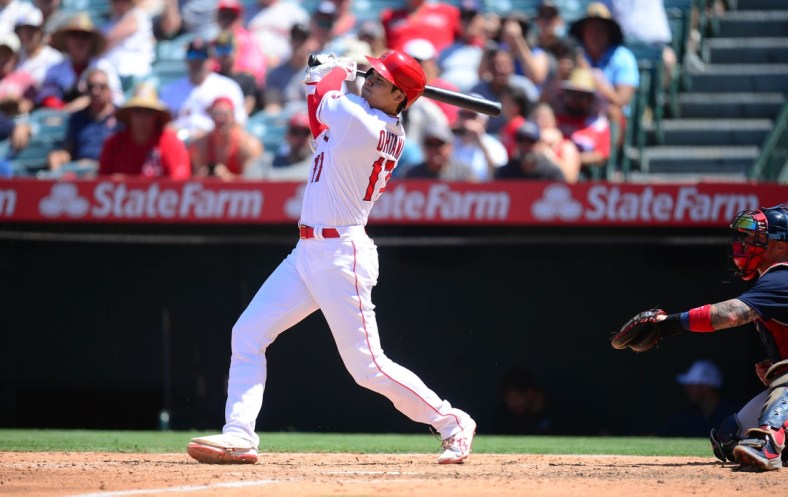 Jul 7, 2021; Anaheim, California, USA; Los Angeles Angels designated hitter Shohei Ohtani (17) hits a solo home run against the Boston Red Sox during the fifth inning at Angel Stadium. Mandatory Credit: Gary A. Vasquez-USA TODAY Sports