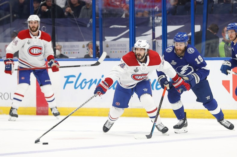 Jul 7, 2021; Tampa, Florida, USA; Montreal Canadiens left wing Phillip Danault (24) reaches for the puck against the Tampa Bay Lightning during the first period in game five of the 2021 Stanley Cup Final at Amalie Arena. Mandatory Credit: Kim Klement-USA TODAY Sports
