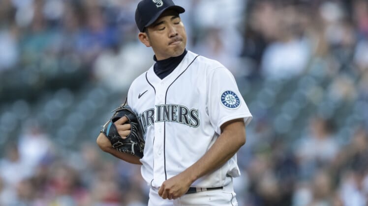 Jul 7, 2021; Seattle, Washington, USA; Seattle Mariners starting pitcher Yusei Kikuchi (18) reacts after giving up a two-run home run to New York Yankees right fielder Aaron Judge (not pictured) during the second inning of a game at T-Mobile Park. Mandatory Credit: Stephen Brashear-USA TODAY Sports