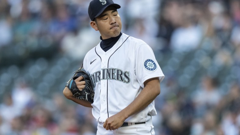 Jul 7, 2021; Seattle, Washington, USA; Seattle Mariners starting pitcher Yusei Kikuchi (18) reacts after giving up a two-run home run to New York Yankees right fielder Aaron Judge (not pictured) during the second inning of a game at T-Mobile Park. Mandatory Credit: Stephen Brashear-USA TODAY Sports