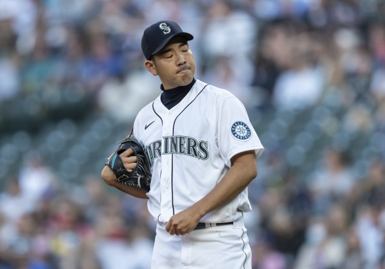 Jul 7, 2021; Seattle, Washington, USA; Seattle Mariners starting pitcher Yusei Kikuchi (18) reacts after giving up a two-run home run to New York Yankees right fielder Aaron Judge (not pictured) during the second inning of a game at T-Mobile Park. Mandatory Credit: Stephen Brashear-USA TODAY Sports