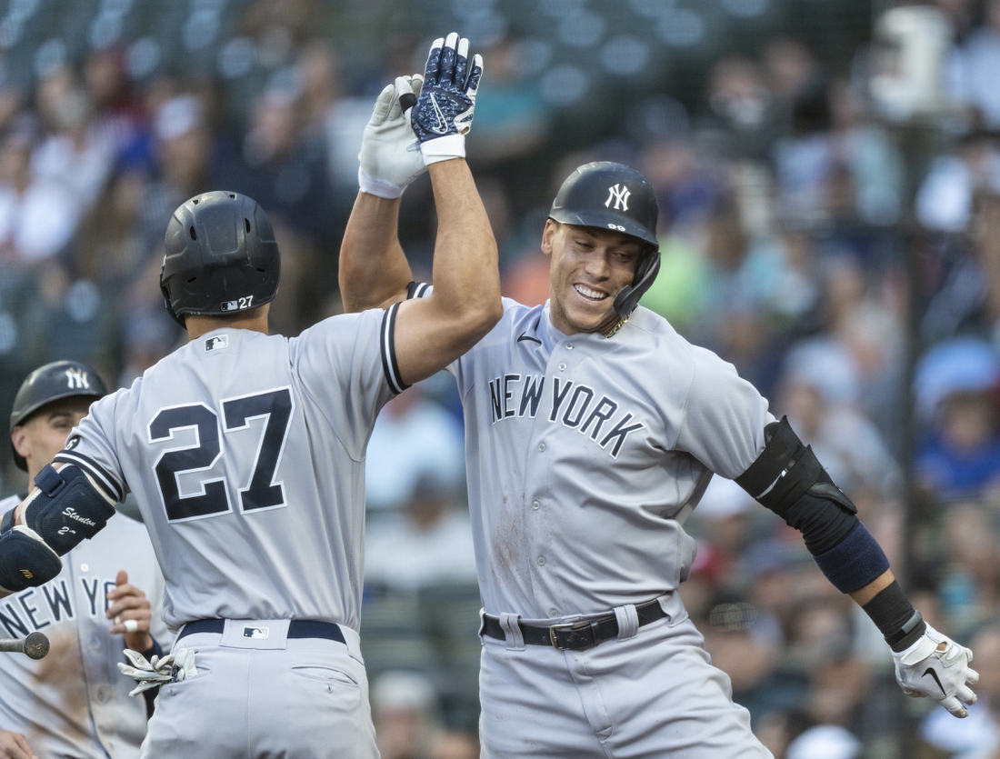 Jul 7, 2021; Seattle, Washington, USA; New York Yankees right fielder Aaron Judge (99) is congratulated by designated hitter Giancarlo Stanton (27) after hitting a two-run home run off of Seattle Mariners starting pitcher Yusei Kikuchi (not pictured) that also scored leftfielder Tim Locastro (not pictured) during the second inning at T-Mobile Park. Mandatory Credit: Stephen Brashear-USA TODAY Sports