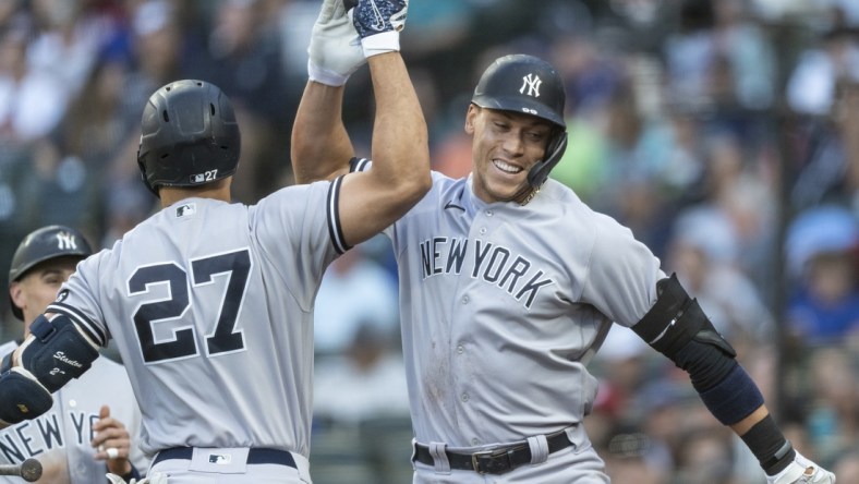 Jul 7, 2021; Seattle, Washington, USA; New York Yankees right fielder Aaron Judge (99) is congratulated by designated hitter Giancarlo Stanton (27) after hitting a two-run home run off of Seattle Mariners starting pitcher Yusei Kikuchi (not pictured) that also scored leftfielder Tim Locastro (not pictured) during the second inning at T-Mobile Park. Mandatory Credit: Stephen Brashear-USA TODAY Sports