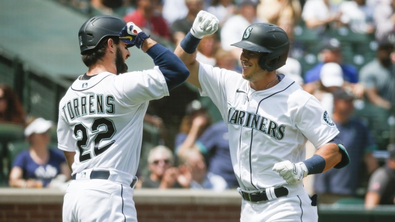 Jul 8, 2021; Seattle, Washington, USA; Seattle Mariners second baseman Dylan Moore (right) celebrates with designated hitter Luis Torrens (22) after hitting a two-run home run against the New York Yankees during the second inning at T-Mobile Park. Mandatory Credit: Joe Nicholson-USA TODAY Sports