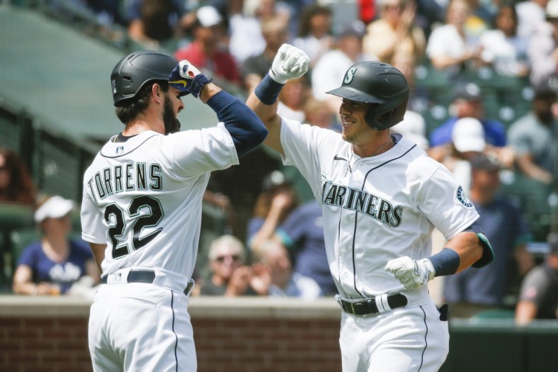 Jul 8, 2021; Seattle, Washington, USA; Seattle Mariners second baseman Dylan Moore (right) celebrates with designated hitter Luis Torrens (22) after hitting a two-run home run against the New York Yankees during the second inning at T-Mobile Park. Mandatory Credit: Joe Nicholson-USA TODAY Sports