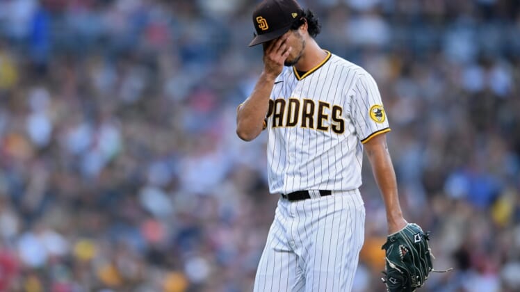 Jul 8, 2021; San Diego, California, USA; San Diego Padres starting pitcher Yu Darvish (11) wipes his face as he walks to the dugout after the last out of the top of the fourth inning at Petco Park. Mandatory Credit: Orlando Ramirez-USA TODAY Sports