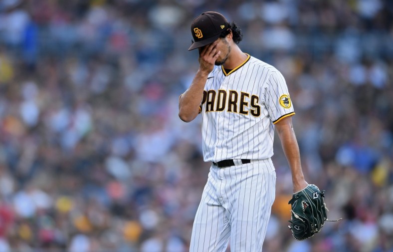 Jul 8, 2021; San Diego, California, USA; San Diego Padres starting pitcher Yu Darvish (11) wipes his face as he walks to the dugout after the last out of the top of the fourth inning at Petco Park. Mandatory Credit: Orlando Ramirez-USA TODAY Sports