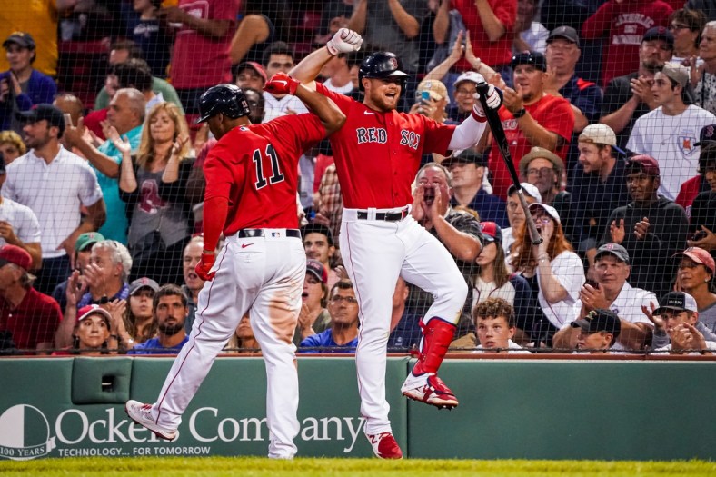 Jul 9, 2021; Boston, Massachusetts, USA; Boston Red Sox third baseman Rafael Devers (11) is congratulated after hitting a home run against the Philadelphia Phillies in the third inning at Fenway Park. Mandatory Credit: David Butler II-USA TODAY Sports
