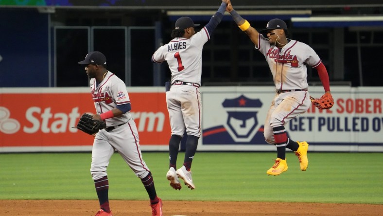 Jul 9, 2021; Miami, Florida, USA; Atlanta Braves second baseman Ozzie Albies (1) and right fielder Ronald Acuna Jr. (13) celebrate after defeating the Miami Marlins at loanDepot park. Mandatory Credit: Jasen Vinlove-USA TODAY Sports