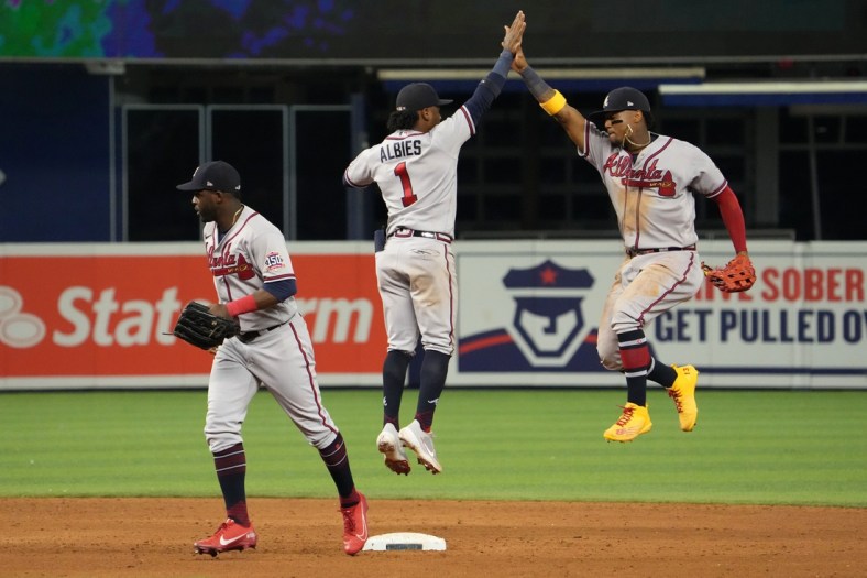 Jul 9, 2021; Miami, Florida, USA; Atlanta Braves second baseman Ozzie Albies (1) and right fielder Ronald Acuna Jr. (13) celebrate after defeating the Miami Marlins at loanDepot park. Mandatory Credit: Jasen Vinlove-USA TODAY Sports