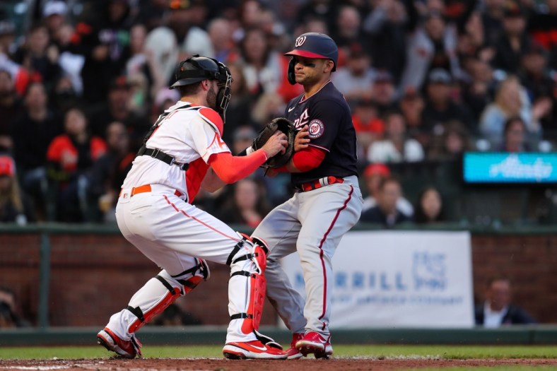 Jul 9, 2021; San Francisco, California, USA; Washington Nationals center fielder Gerardo Parra gets tagged out at home plate by San Francisco Giants catcher Curt Casali (2) during the fourth inning at Oracle Park. Mandatory Credit: Sergio Estrada-USA TODAY Sports