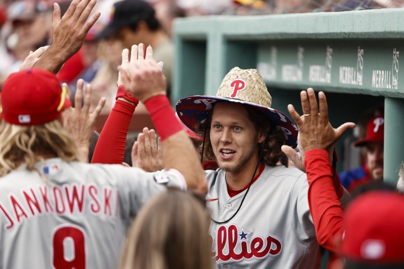 Jul 10, 2021; Boston, Massachusetts, USA; Philadelphia Phillies third baseman Alec Bohm (28) is congratulated by teammates in the dugout after his two run home run against the Boston Red Sox during the second inning at Fenway Park. Mandatory Credit: Winslow Townson-USA TODAY Sports