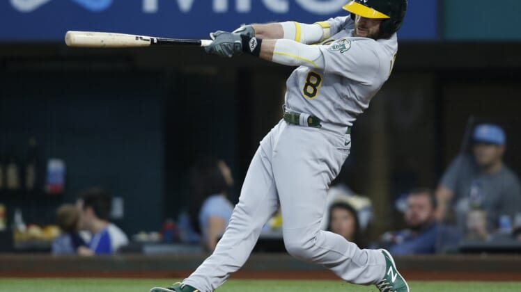 Jul 10, 2021; Arlington, Texas, USA; Oakland Athletics designated hitter Jed Lowrie (8) hits a home run in the fourth inning against the Texas Rangers at Globe Life Field. Mandatory Credit: Tim Heitman-USA TODAY Sports