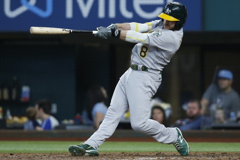 Jul 10, 2021; Arlington, Texas, USA; Oakland Athletics designated hitter Jed Lowrie (8) hits a home run in the fourth inning against the Texas Rangers at Globe Life Field. Mandatory Credit: Tim Heitman-USA TODAY Sports