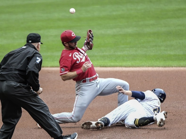 Jul 10, 2021; Milwaukee, Wisconsin, USA; Milwaukee Brewers third baseman Luis Urias (2) steals second base as Cincinnati Reds shortstop Mike Freeman (27) bobbles the ball in the first inning at American Family Field. Mandatory Credit: Benny Sieu-USA TODAY Sports