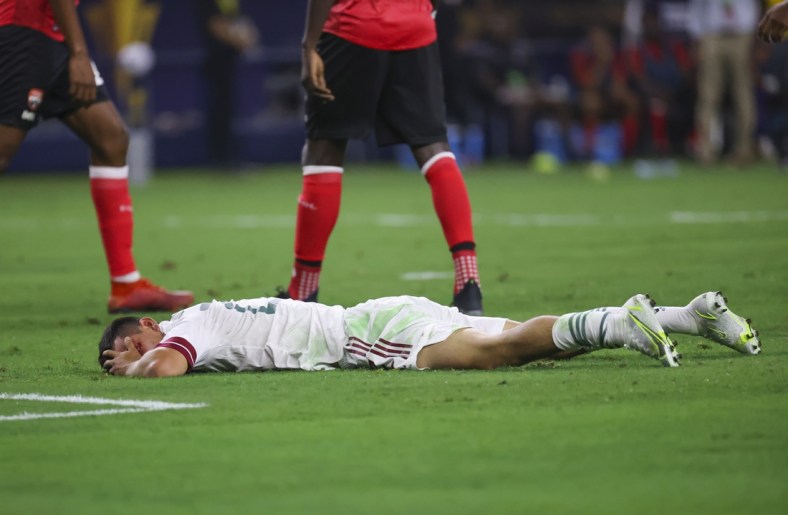 Jul 10, 2021; Arlington, Texas, USA; Mexico forward Hirving Lozano (22) lays injured during the first half of a CONCACAF Gold Cup group stage soccer match against the Trinidad and Tobago at AT&T Stadium. Mandatory Credit: Kevin Jairaj-USA TODAY Sports