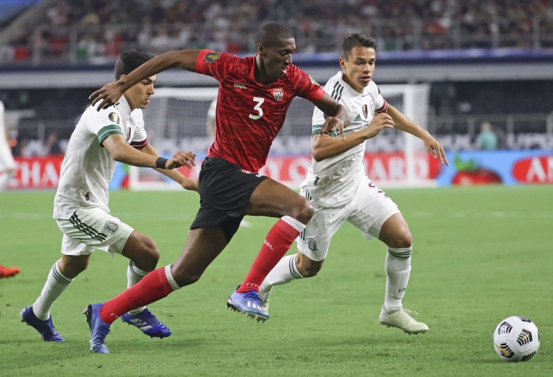 Jul 10, 2021; Arlington, Texas, USA; Trinidad and Tobago midfielder Hashim Archia (3) and Mexico defender Osvaldo Rodriguez (5) go for the ball during the first half of a CONCACAF Gold Cup group stage soccer match at AT&T Stadium. Mandatory Credit: Kevin Jairaj-USA TODAY Sports
