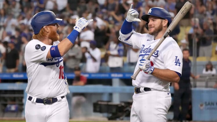 Jul 10, 2021; Los Angeles, California, USA; Los Angeles Dodgers third baseman Justin Turner (10) celebrates with second baseman Max Muncy (right) after hitting a grand slam home run against the Arizona Diamondbacks in the second inning at Dodger Stadium. Mandatory Credit: Kirby Lee-USA TODAY Sports