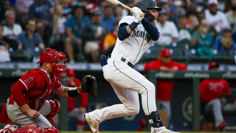 Jul 10, 2021; Seattle, Washington, USA; Seattle Mariners center fielder Jake Fraley (28) hits into a fielders choice to drive in a run against the Los Angeles Angels during the fourth inning at T-Mobile Park. Mandatory Credit: Joe Nicholson-USA TODAY Sports